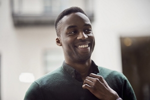 Smartly-dressed man with a taper fade wearing a green shirt